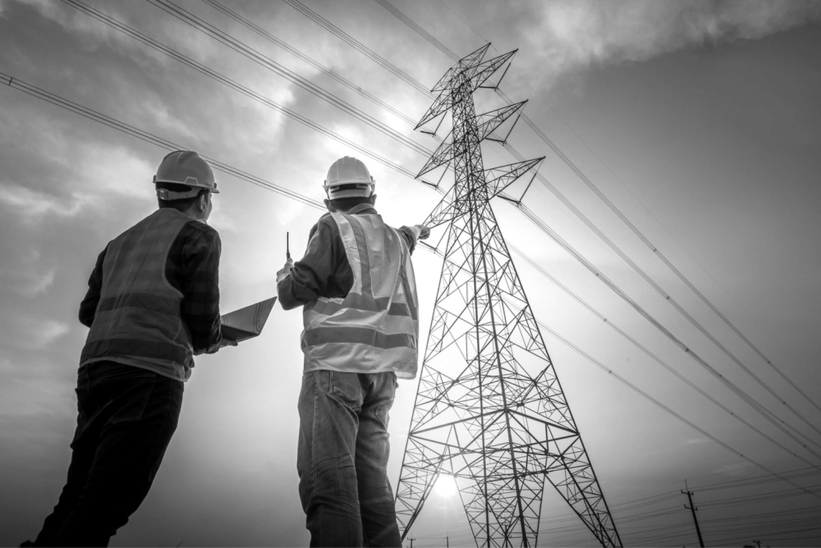 Electrical engineers inspecting high-voltage transmission infrastructure